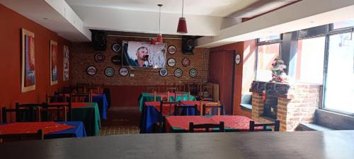 a dining room with colorful tables and chairs at Kilometro Cero in La Quiaca