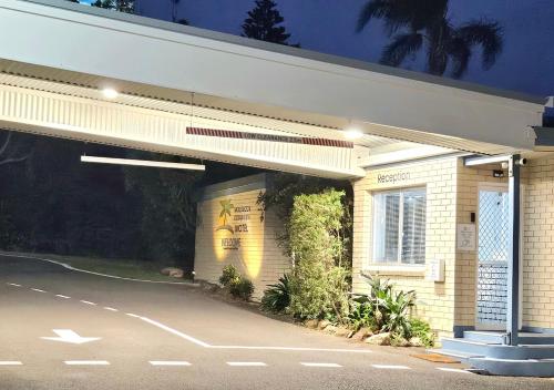 a gas station at night with a lit up building at Mollymook Ocean View Motel - Welcoming Guests 18 Years and Older in Mollymook