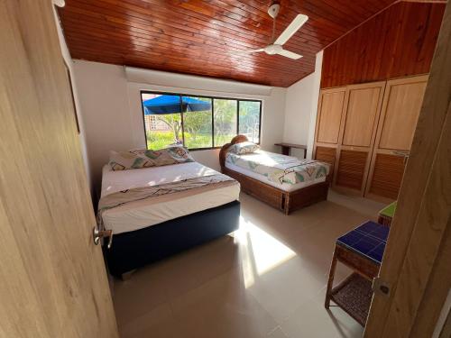 En eller flere senge i et værelse på Cabaña - Condominio El Rincón del Edén