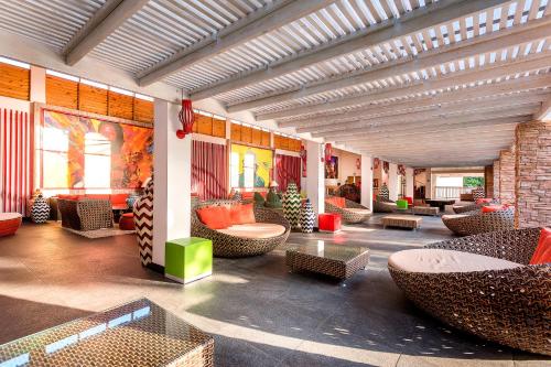 a lobby with couches and tables and chairs at Decameron Isleño - All Inclusive in San Andrés