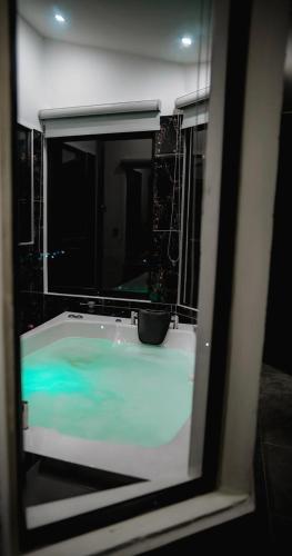 a bathroom with a bath tub with a window at Esmeralda DELUXE in San Gil