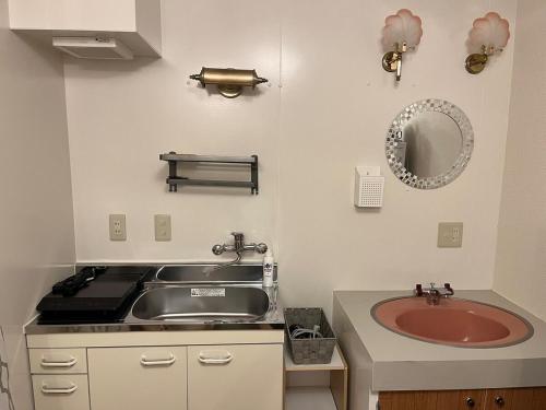 a small kitchen with a sink and a sink at 202basichostel in Osaka
