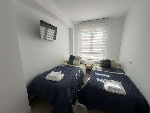 En eller flere senge i et værelse på Apartamentos Turísticos Las Claras 2