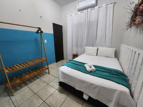 a bedroom with a bed with a teddy bear on it at Mini Hostel in Tutóia