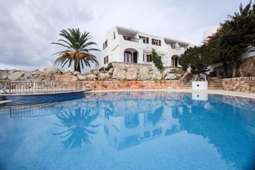 una gran piscina frente a una casa en Duplex Es Brucs, en Cala Morell