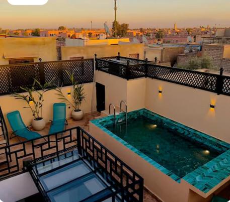 a balcony with a swimming pool on a building at Riad Marhaba in Marrakesh