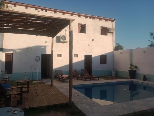 a house with a swimming pool and a building at Complejo la Raquel in Goya