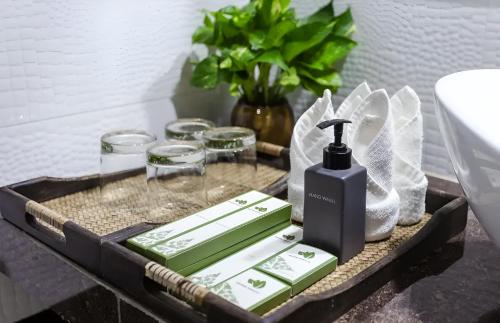 a black tray with a soap dispenser on a bathroom counter at De Arya Angkor Resort in Siem Reap