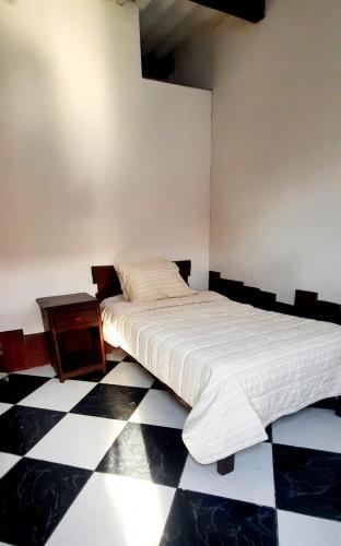 a bedroom with a bed and a checkered floor at Sunset bed in Puerto Chicama