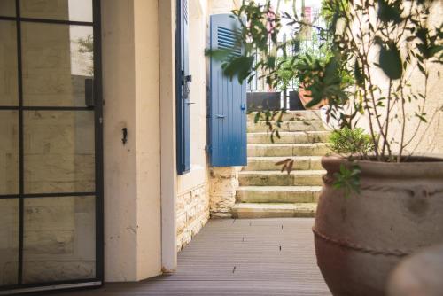 a plant in a large pot in front of a door at Hotel Edouard VII in Biarritz