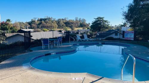 a swimming pool with blue water in a yard at Rodeway Inn Jackson in Jackson