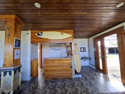 a surf shop with a surfboard on the wall at suffers villa medewi in Medewi
