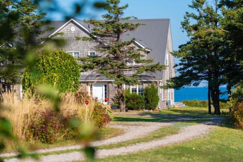 een huis met een grindoprit die naar een huis leidt bij Blue Ocean Cove Beach House in Saint Peters