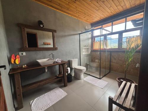 a bathroom with a sink and a toilet at Pousada Morada Canto do Sol in São Bento do Sapucaí