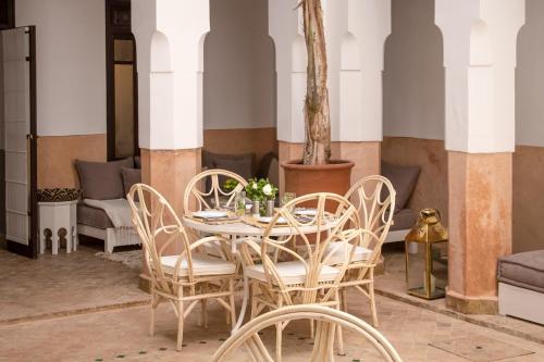 uma sala de jantar com mesa e cadeiras em Riad Olema et Spa em Marrakech