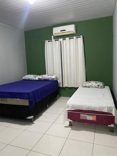 Een bed of bedden in een kamer bij Pousada Andrade