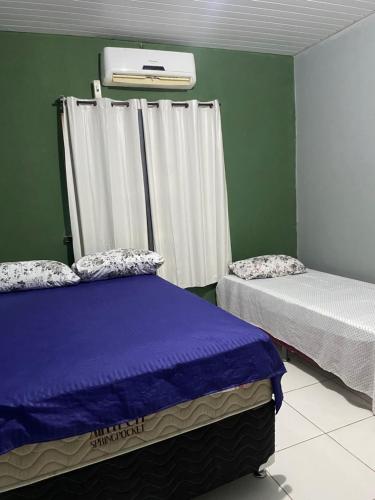 Een bed of bedden in een kamer bij Pousada Andrade