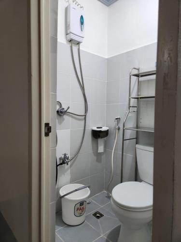 a bathroom with a toilet and a shower in it at Teachers Home in Panong