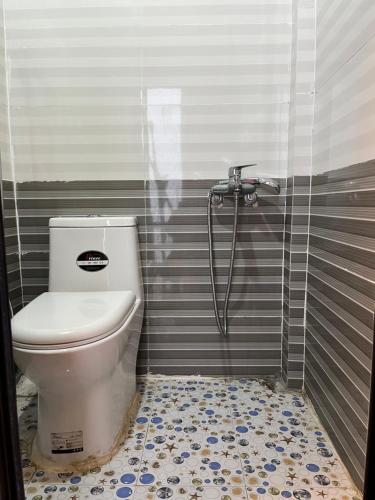 a bathroom with a toilet and a shower at Chi Homestay in Sapa