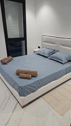 a bed with two pillows on top of it at loft in El Aouina Station