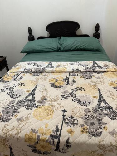 a bed with a quilt on top of it at O E Liburd Residence in Charlestown