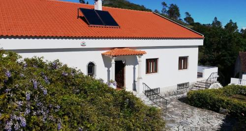a white church with an orange roof at Meio Country House in Alcanede