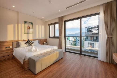 a bedroom with a large bed and a large window at Grand Lux by BRIO in Danang
