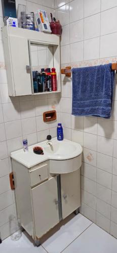 a bathroom with a sink and a blue towel at Casa do Fernando in São Gabriel