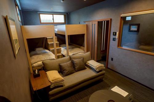 a living room with bunk beds and a couch at PREMIUM O2stay citrus onomichi in Onomichi