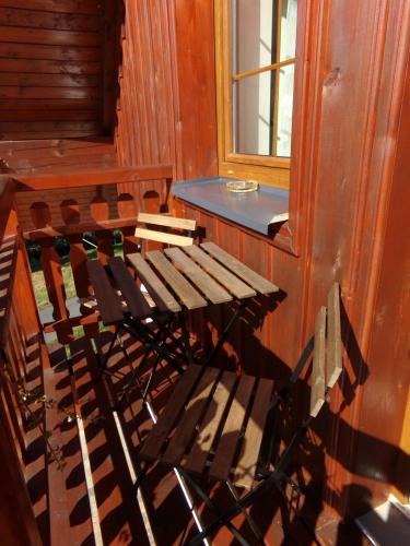 a table and chairs in a room with a window at Apartment Nedrik in Rokytnice nad Jizerou
