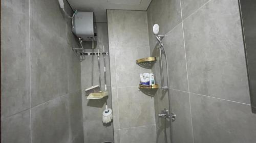 a bathroom with a shower stall with a shower at Dewi's Pollux in Batam Center