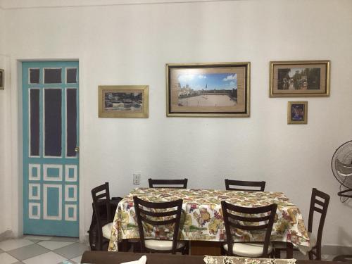 a dining room with a table with chairs and a blue door at Entire accommodation Departamento Mi Mexico in Mexico City