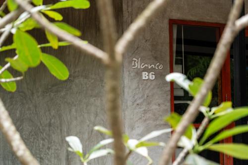 a building with a sign on the side of it at Blanco Hostel Lanta 18 to 35 in Ko Lanta