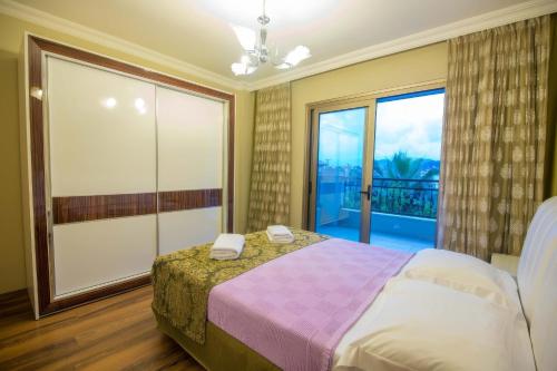une chambre avec un lit et une grande fenêtre dans l'établissement Mete 2 Villa İcmeler Marmaris, à İçmeler