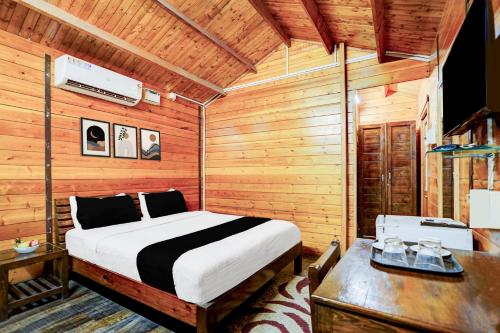 een slaapkamer met een bed in een houten kamer bij Townhouse Morjim in Goa