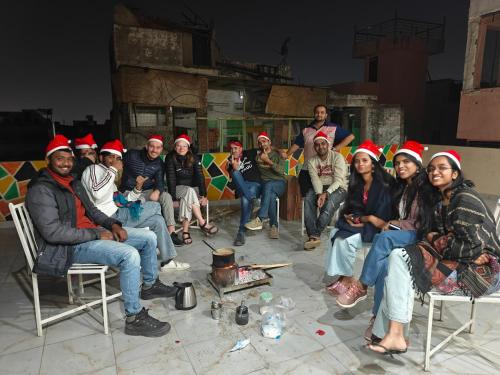 a group of people wearing christmas hats posing for a picture at The Pink Nest - Backpackers Abode in Jaipur