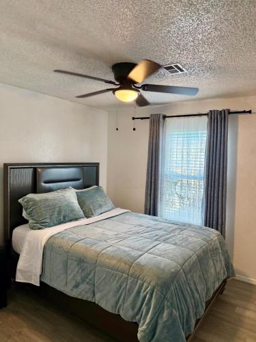 a bedroom with a bed with a ceiling fan at Emmanuel House in Tulsa