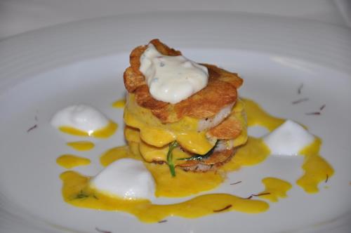 a white plate with a dessert with bacon and sauce at Hotel Central in Seefeld in Tirol