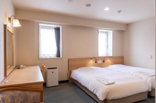 En eller flere senge i et værelse på Ace Inn Matsumoto