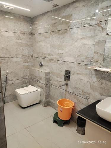 a bathroom with a toilet and a sink at HOTEL UMA PALACE in Gorakhpur