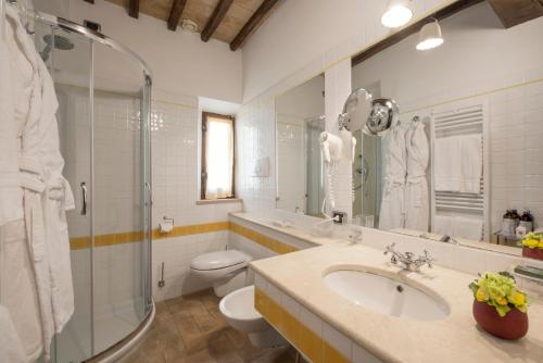 a bathroom with a sink and a toilet and a shower at Relais Osteria Dell'Orcia in Bagno Vignoni