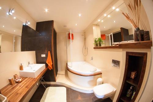 a bathroom with a sink and a toilet and a sink at Monte Cassino Apartament in Sopot