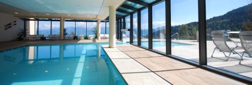 a swimming pool in a house with a view of the mountains at Hotel Monte Bondone in Vaneze