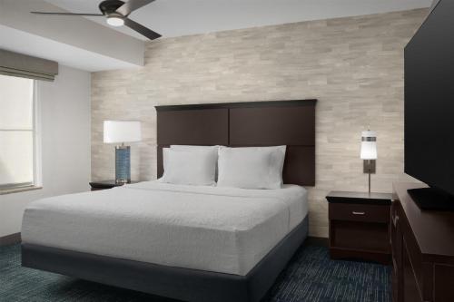 a hotel room with a bed and a television at Hampton Inn & Suites Denver Tech Center in Centennial