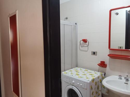 a washing machine in a bathroom with a sink at Appartamento Eucalpti Baia Verde By Nonsolomare Case Vacanze srlu in Baia Di Gallipoli