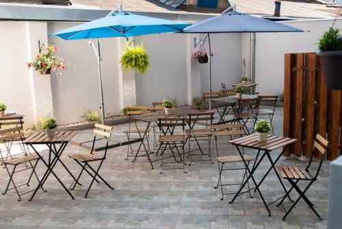 an outdoor patio with tables and chairs and umbrellas at Residence Vysta in Prague