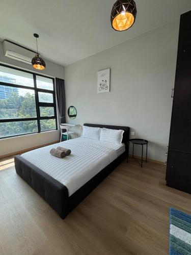 a bedroom with a large bed in a room at Jesselton Quay by SNUG SPACE in Kota Kinabalu