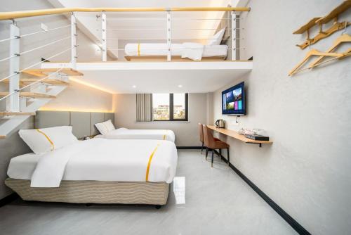 a hotel room with two beds and a staircase at Shanghai Rui deng hao Hotel-Free shuttle bus to Airport and Disneyland 24x7 in Shanghai