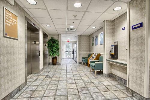 a hallway of a hospital with couches and chairs at Motel 6-London, ON - Ontario in London