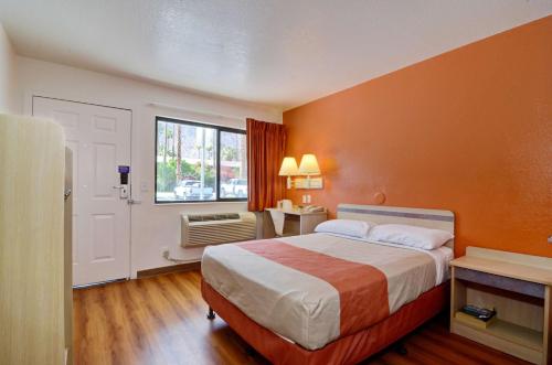 a hotel room with a bed and a window at Motel 6-Palm Springs, CA - East - Palm Canyon in Palm Springs